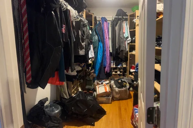 a view of walk in closet with clothes and shoes