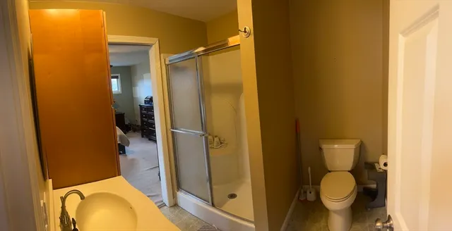 a bathroom with a toilet and a shower