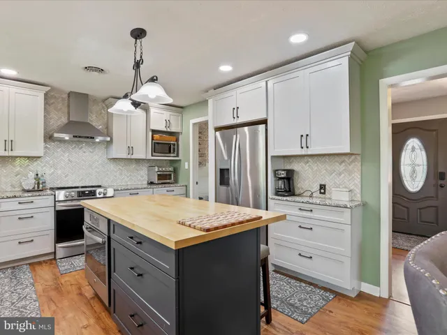 a kitchen with a sink stove and refrigerator