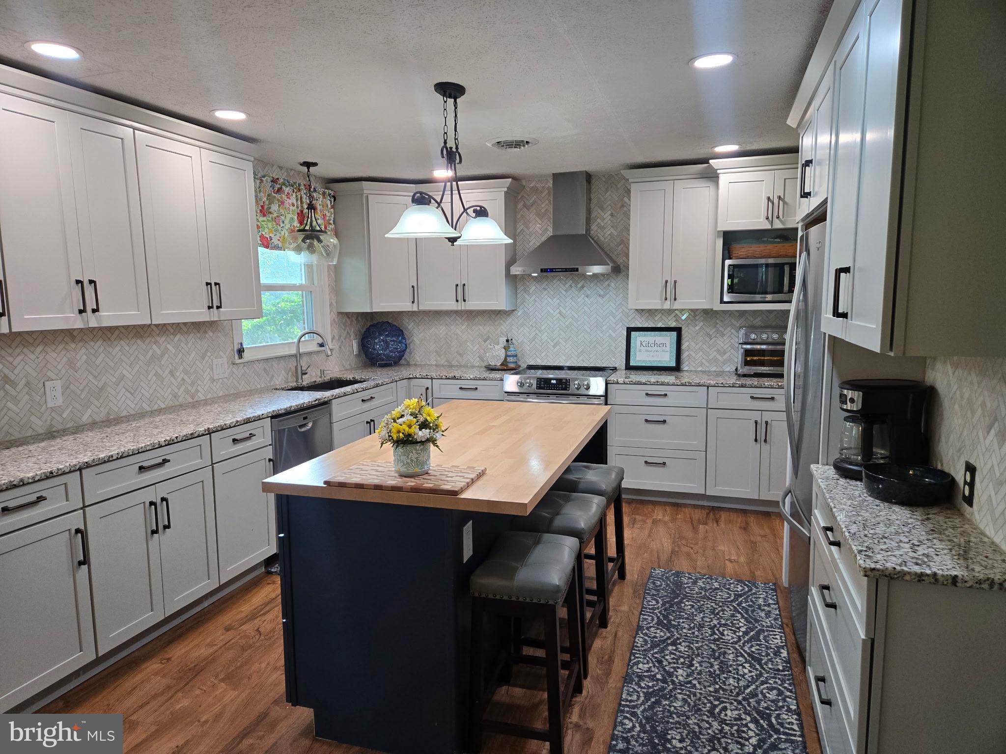 26 Kensington Drive Chambersburg, PA 17201 - Photo 18 of 44 a kitchen with stainless steel appliances kitchen island granite countertop a sink a stove and cabinets