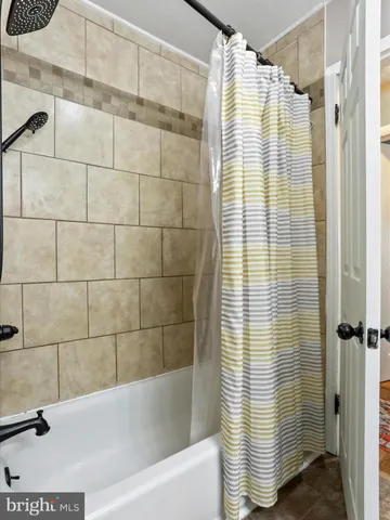 a bathroom with a shower and a bathtub