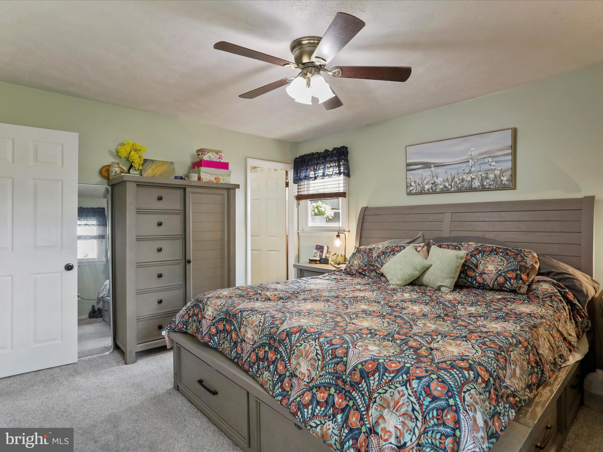 26 Kensington Drive Chambersburg, PA 17201 - Photo 25 of 44 a bedroom with a bed a dresser and a chandelier