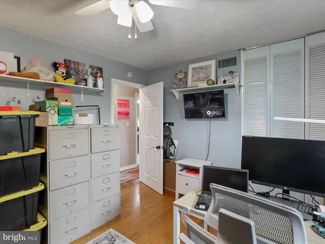 a bedroom with a workspace