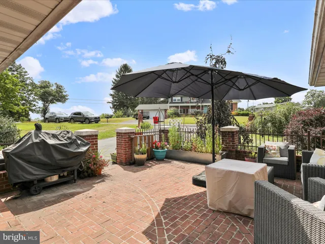 a view of a roof deck with furniture