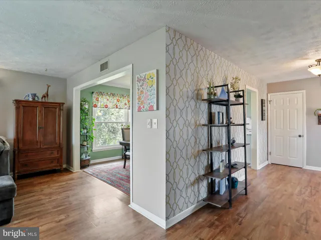 a view of entryway with wooden floor and stairs