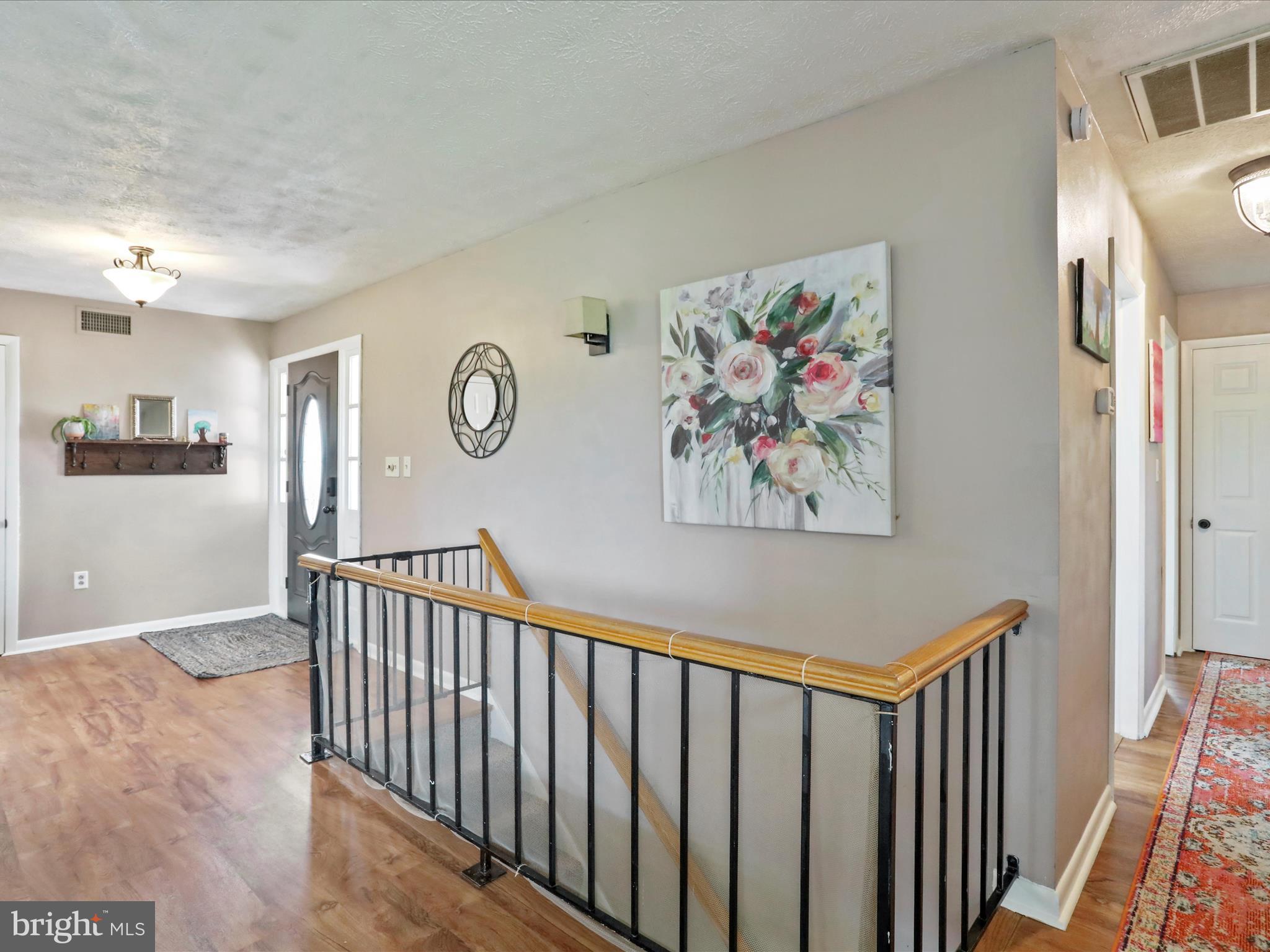 26 Kensington Drive Chambersburg, PA 17201 - Photo 10 of 44 a view of entryway with stairs and wooden floor