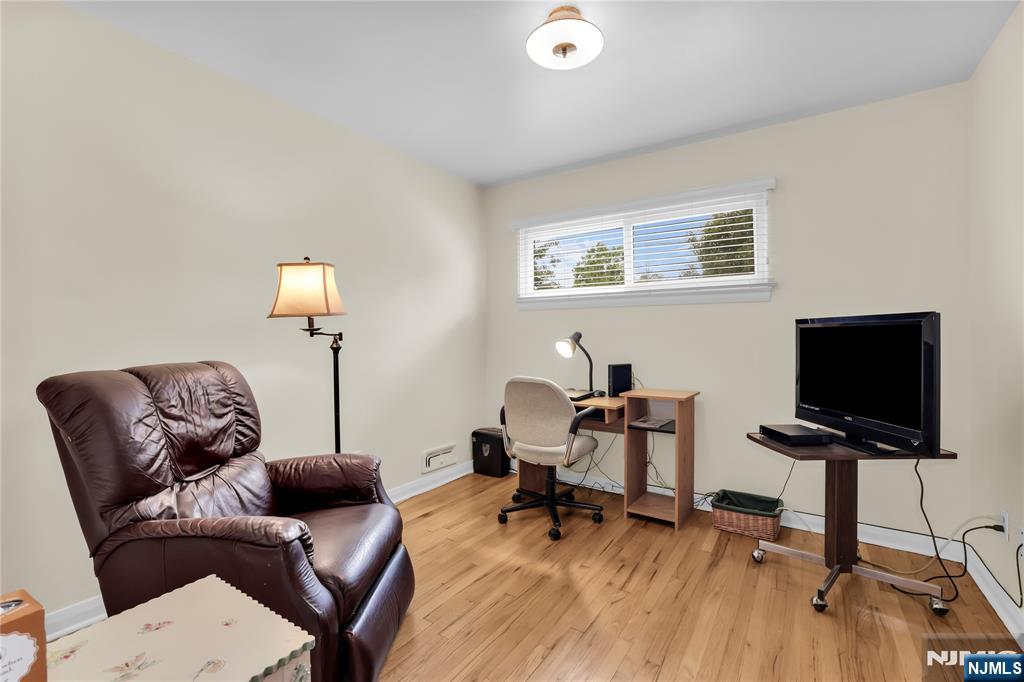 23 Ridge Court Cedar Grove, NJ 07009 - Photo 18 of 37 a work room with furniture and a flat screen tv