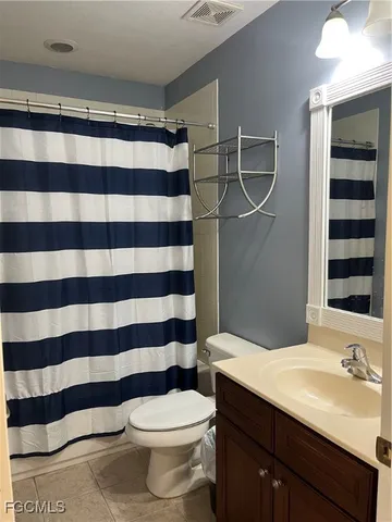 a bathroom with a sink a toilet a shower and a mirror