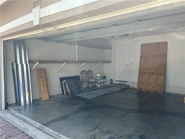 a view of a livingroom with entryway and fireplace