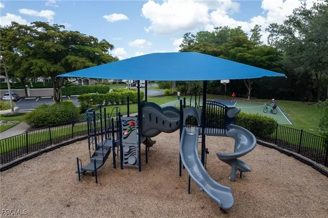 a view of a slide with sitting area and backyard