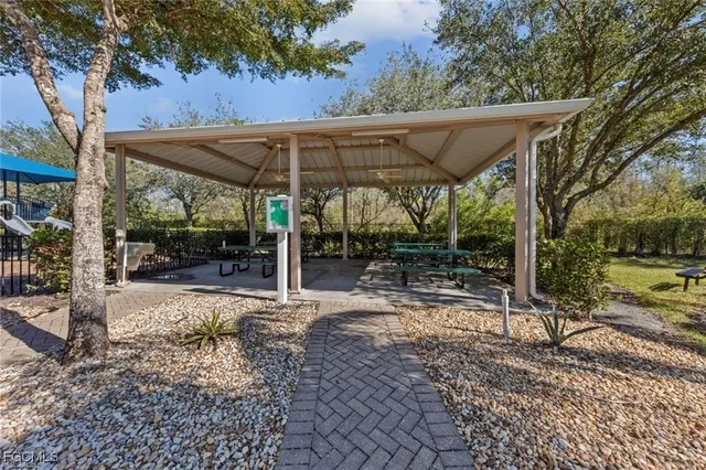a view of a patio with a table chairs and a backyard