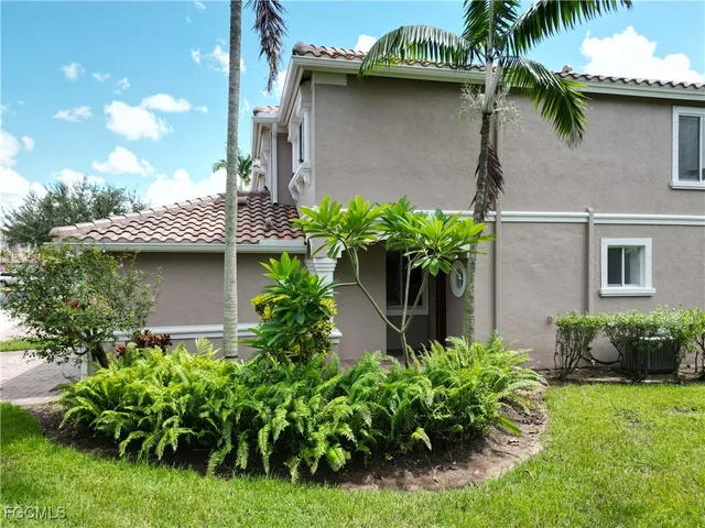a potted plant sitting in front of a house