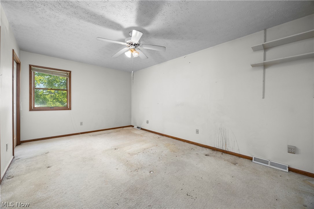 722 Jaycox Road Avon Lake, OH 44012 - Photo 29 of 48 Spacious room featuring a ceiling fan with integrated lighting, wood-trimmed window, and integrated wall shelving