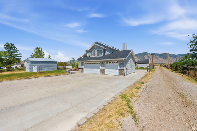 3732 Campbell Road Tooele, UT 84074 - Photo 2 of 69 Two-story residence featuring light gray siding, stone accents, and a dark shingle roof