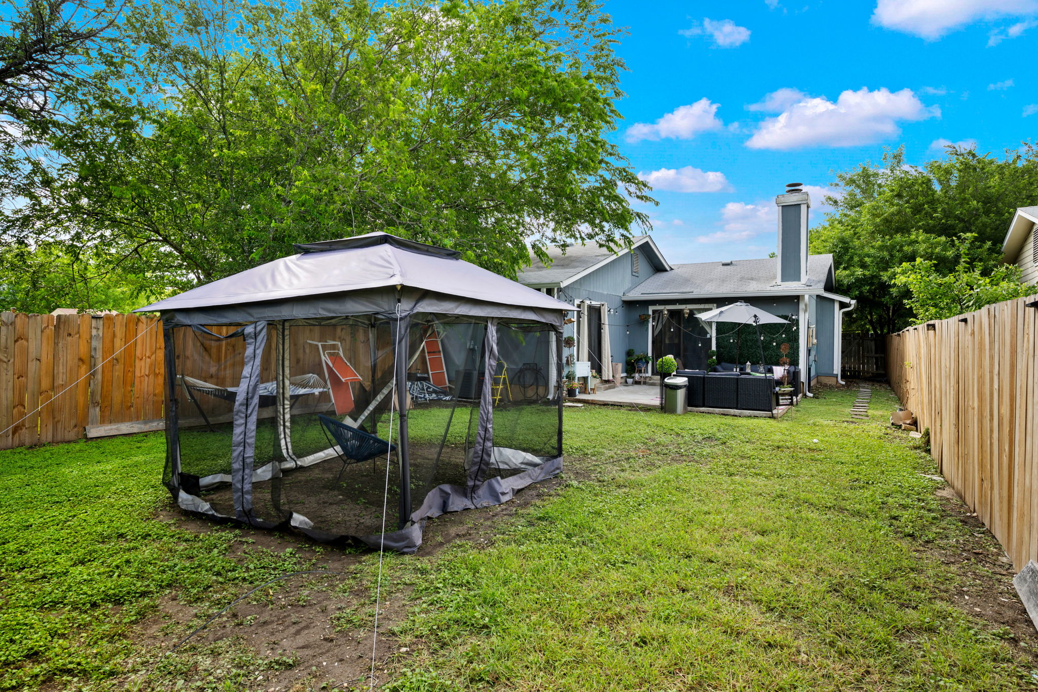 8317 Forest Ridge Drive San Antonio, TX 78239 - Photo 21 of 26 A spacious yard boasts a screened gazebo, offering a private outdoor retreat.