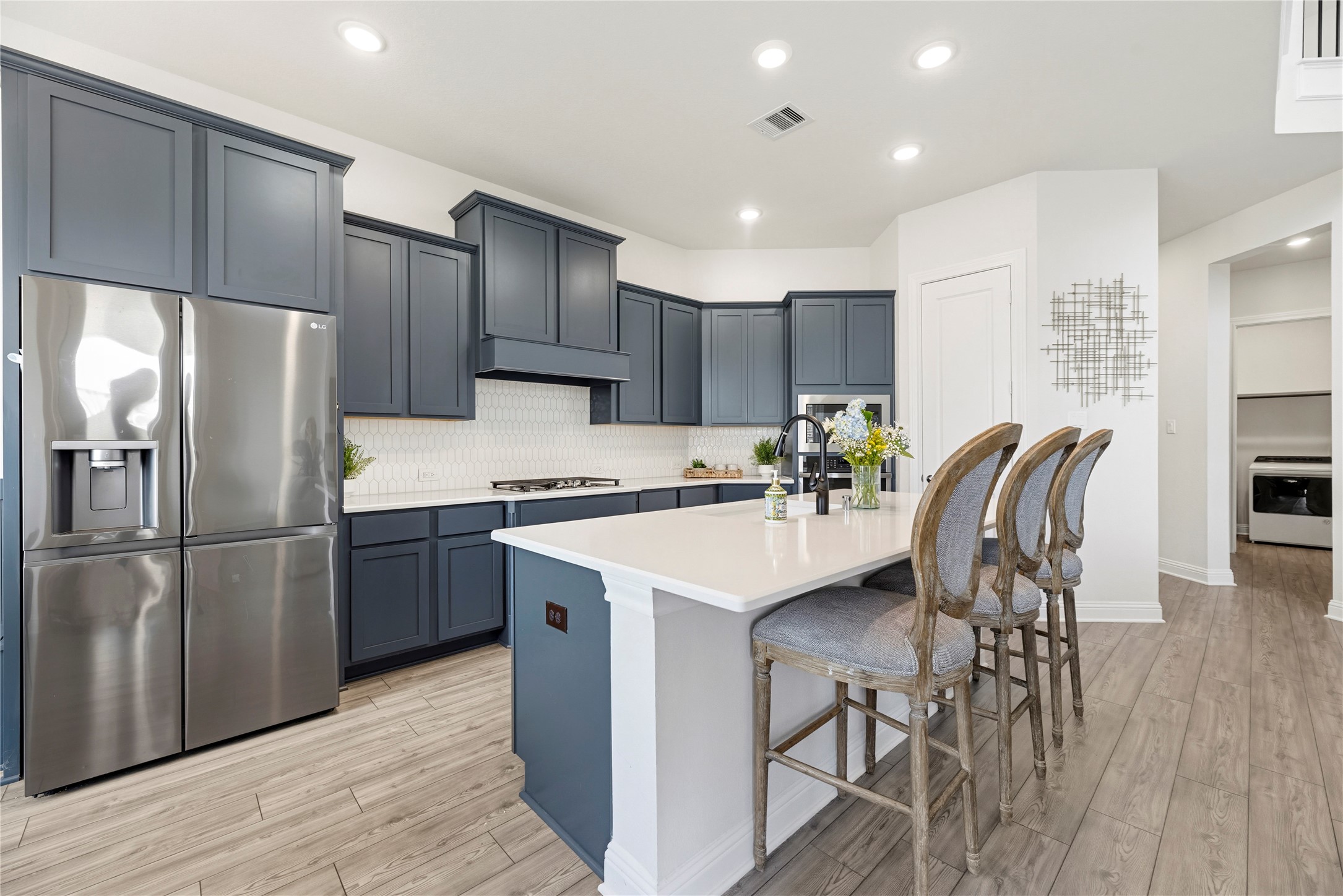 10702 Port Harrison Road Cypress, TX 77433 - Photo 16 of 45 Stunning kitchen with light countertops, shaker style cabinetry, stainless steel appliances and a walk-in pantry.
