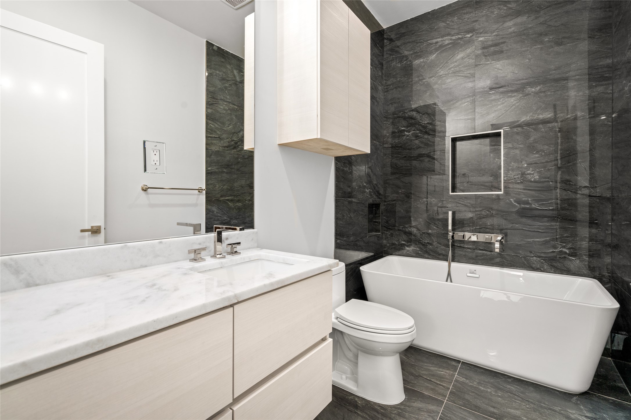 625 Piney Point Road Houston, TX 77024 - Photo 22 of 42 a bathroom with a toilet sink and mirror