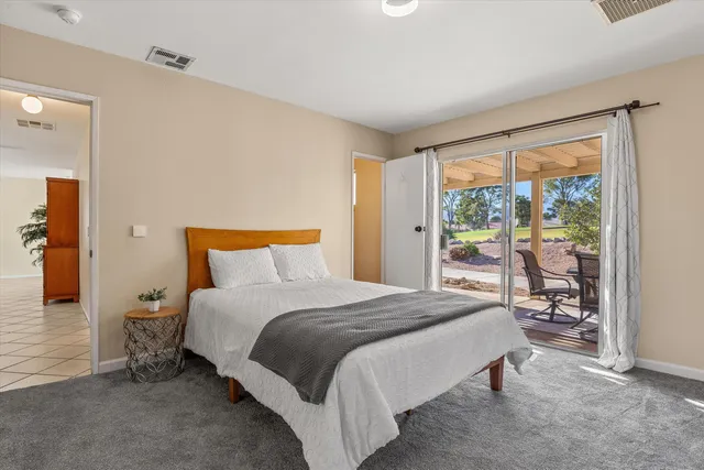 a view of a patio with a table chairs and a swimming pool