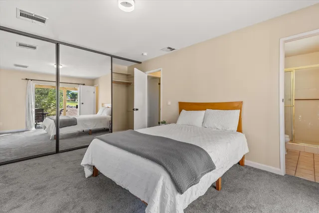 a view of a house with a backyard and a tree