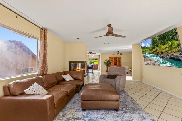 a living room with furniture a dining table and a fireplace