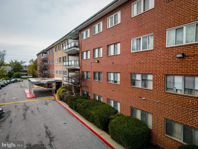 a front view of a house with garden and parking