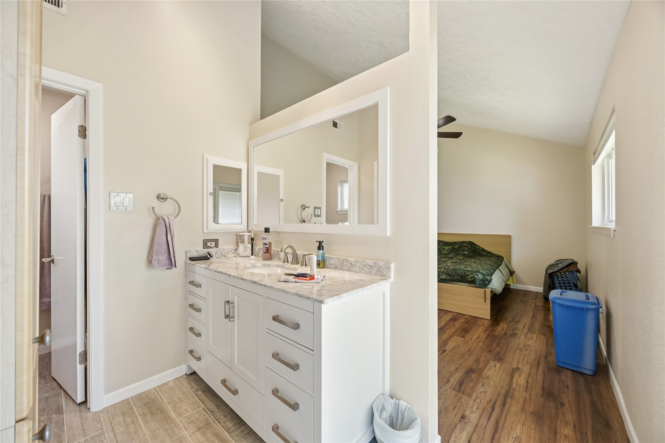 9635 Birsay Street Spring, TX 77379 - Photo 19 of 24 a en suite bathroom with a double vanity sink and a mirror