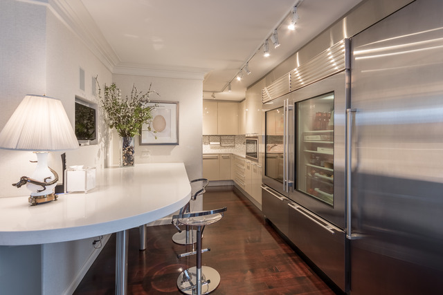 1630 Sheridan Road, Unit 4EF Wilmette, IL 60091 - Photo 9 of 25 a kitchen with kitchen island a counter top space a sink stainless steel appliances and cabinets