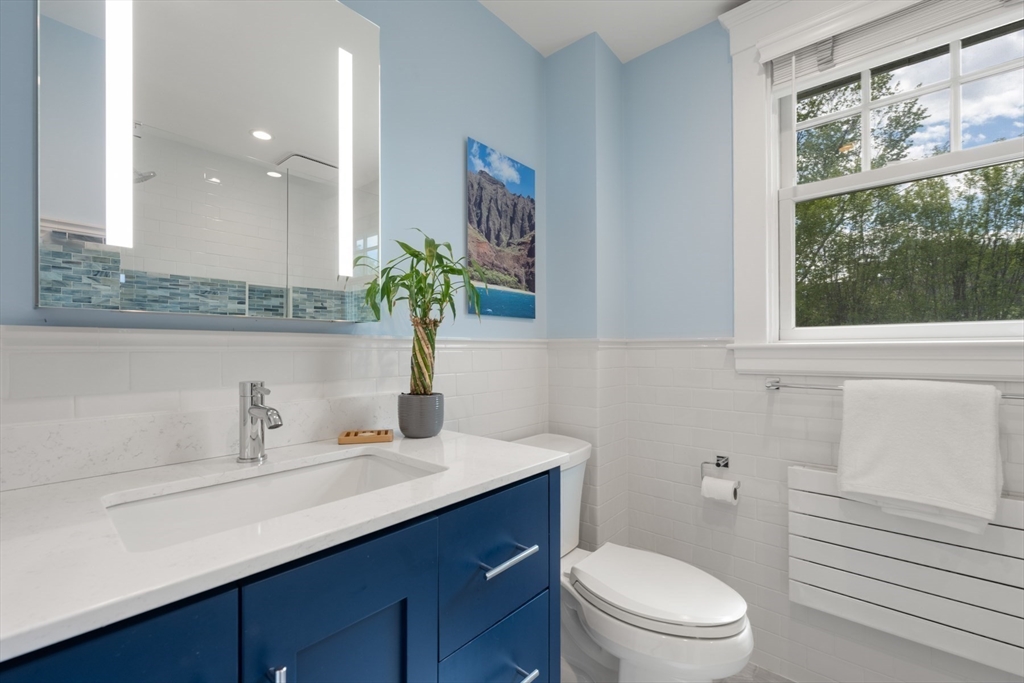8 Charlotte Road Marblehead, MA 01945 - Photo 21 of 37 a bathroom with a sink a toilet a large mirror and shower
