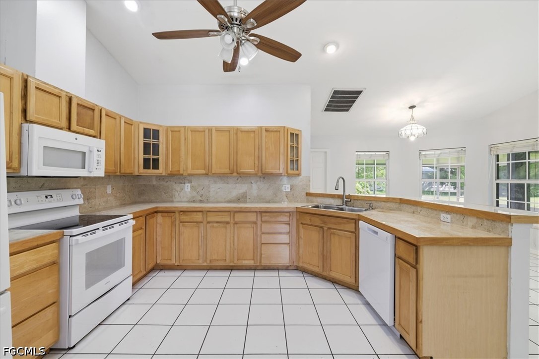 4530 Springview Circle LaBelle, FL 33935 - Photo 17 of 46 a kitchen with a sink a stove cabinets and stainless steel appliances