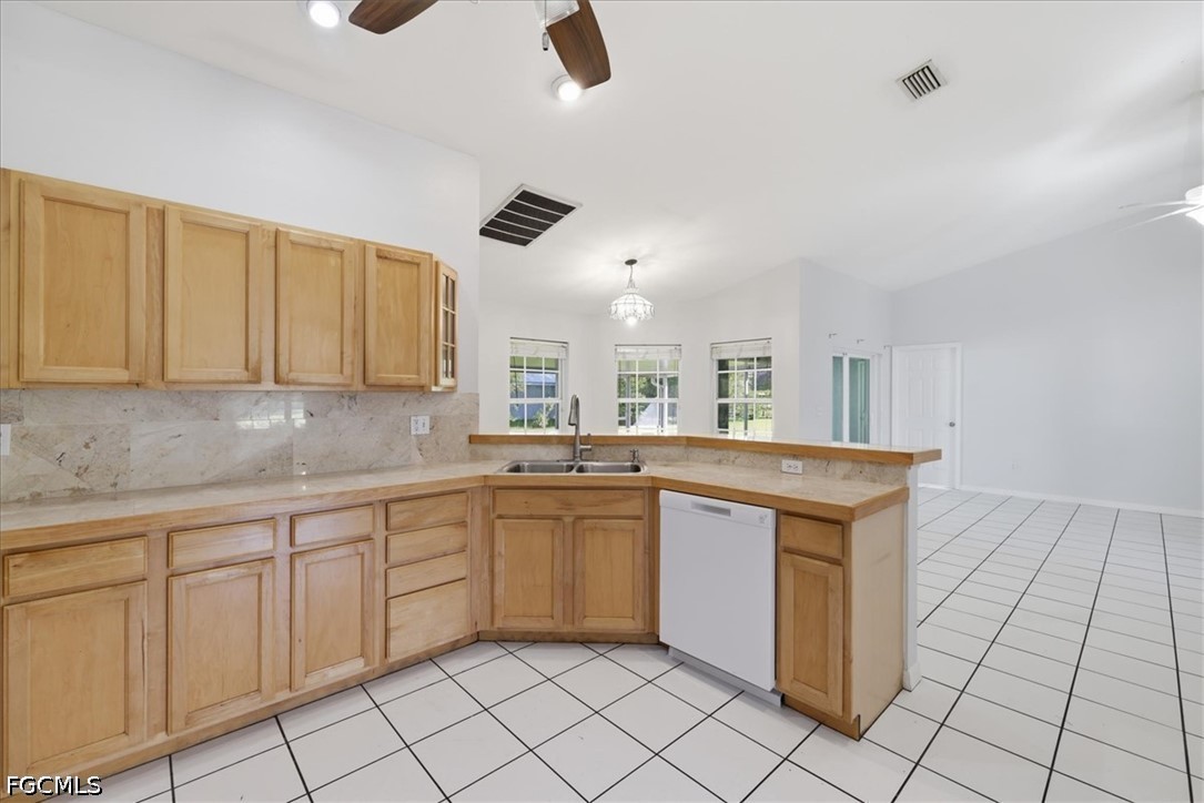 4530 Springview Circle LaBelle, FL 33935 - Photo 18 of 46 a kitchen with white cabinets a sink and appliances