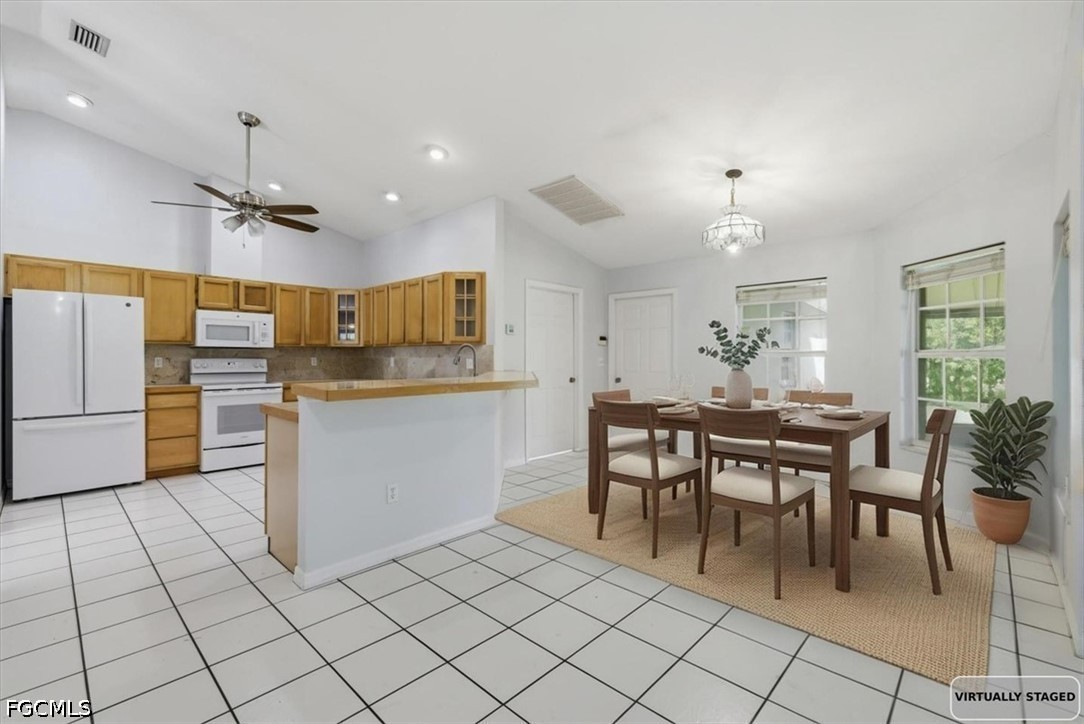 4530 Springview Circle LaBelle, FL 33935 - Photo 2 of 46 a kitchen with stainless steel appliances kitchen island granite countertop a table chairs sink and cabinets