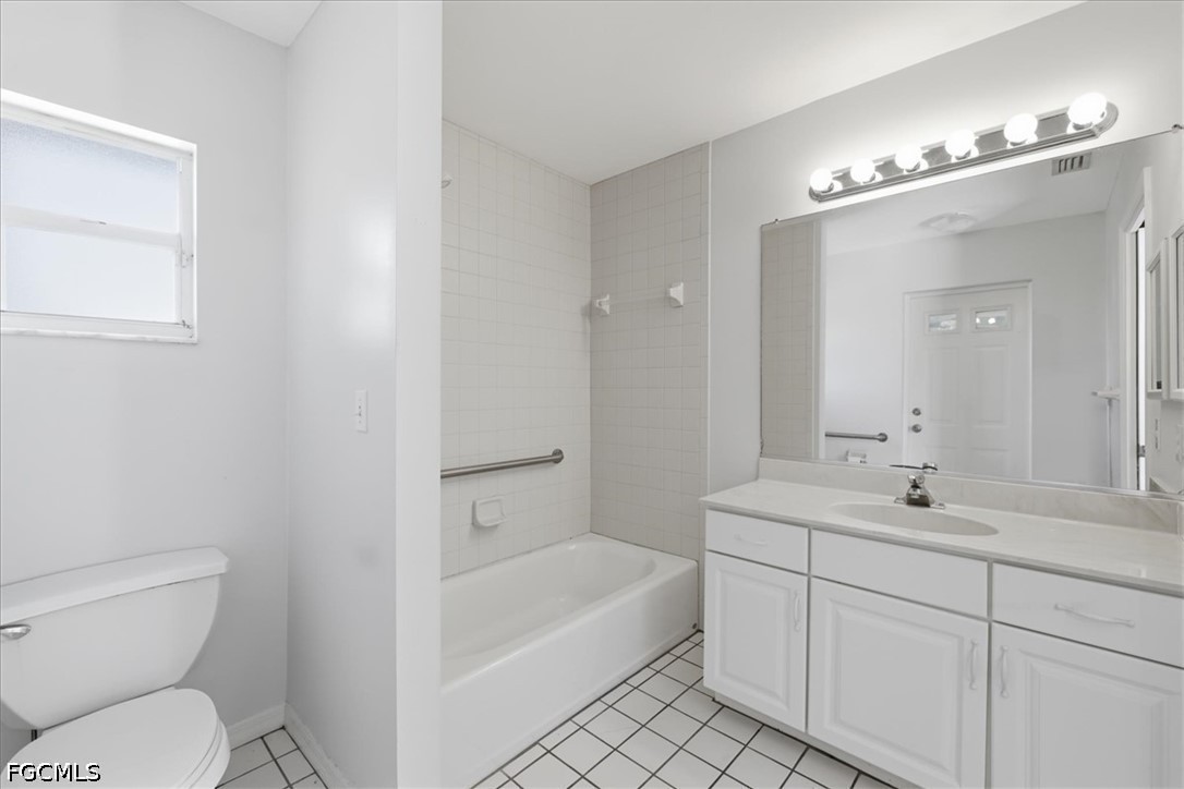 4530 Springview Circle LaBelle, FL 33935 - Photo 26 of 46 a bathroom with a toilet a sink a mirror a bathtub and vanity