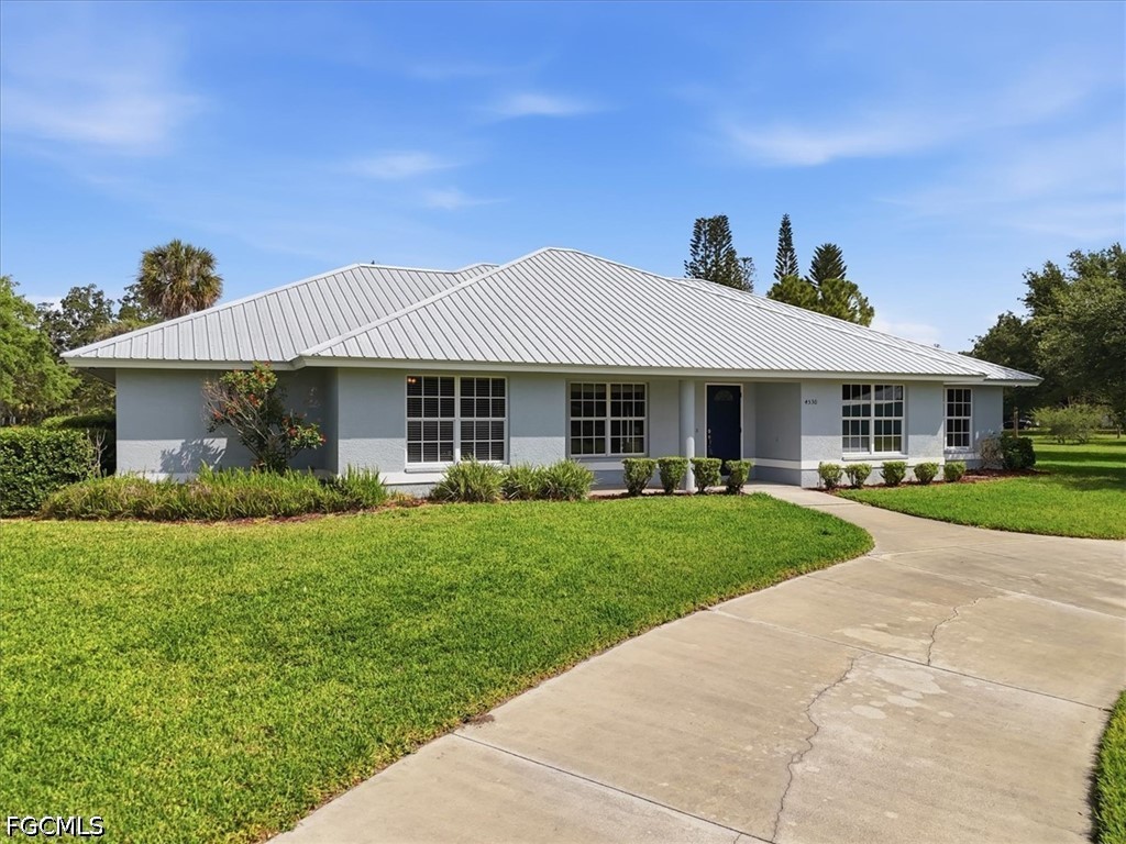 4530 Springview Circle LaBelle, FL 33935 - Photo 38 of 46 a front view of a house with a yard