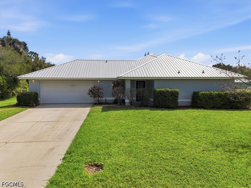4530 Springview Circle LaBelle, FL 33935 - Photo 39 of 46 a front view of a house with a garden