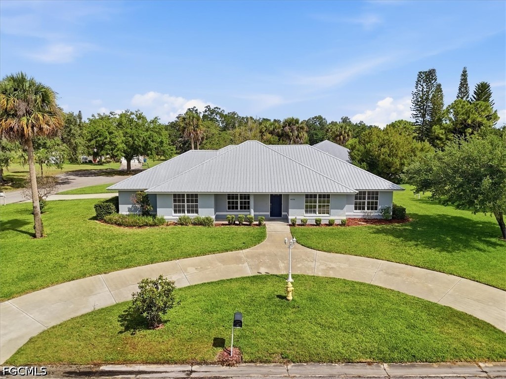 4530 Springview Circle LaBelle, FL 33935 - Photo 43 of 46 a front view of a house with garden