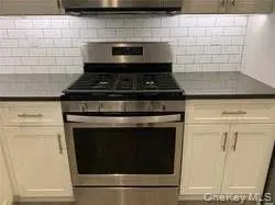 a stove top oven sitting inside of a kitchen