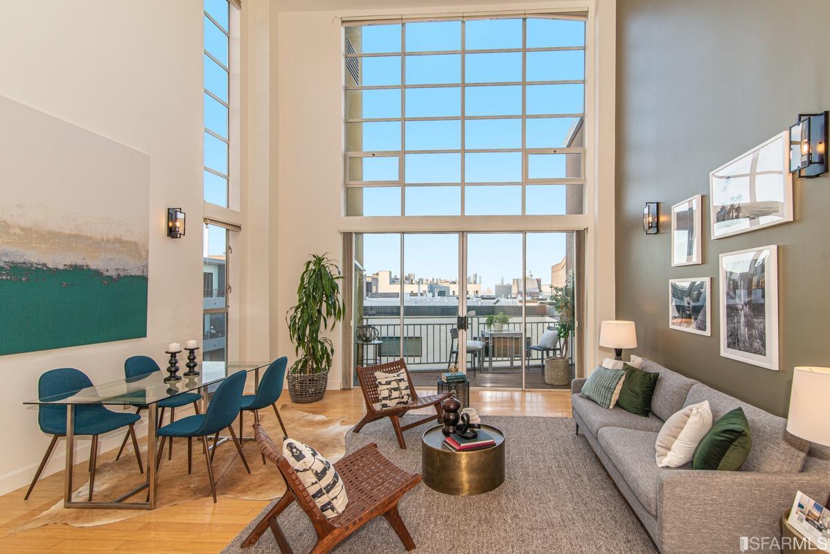 a living room with furniture and a floor to ceiling window