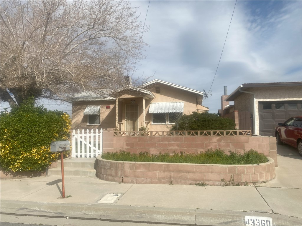 43360-43360 7th Street East Lancaster, CA 93535 - Photo 14 of 14 a front view of a house with trees