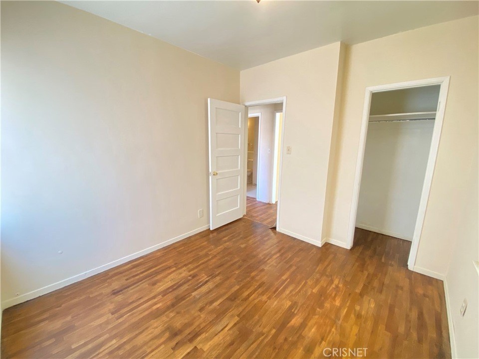 43360-43360 7th Street East Lancaster, CA 93535 - Photo 8 of 14 a view of an empty room with wooden floor and closet