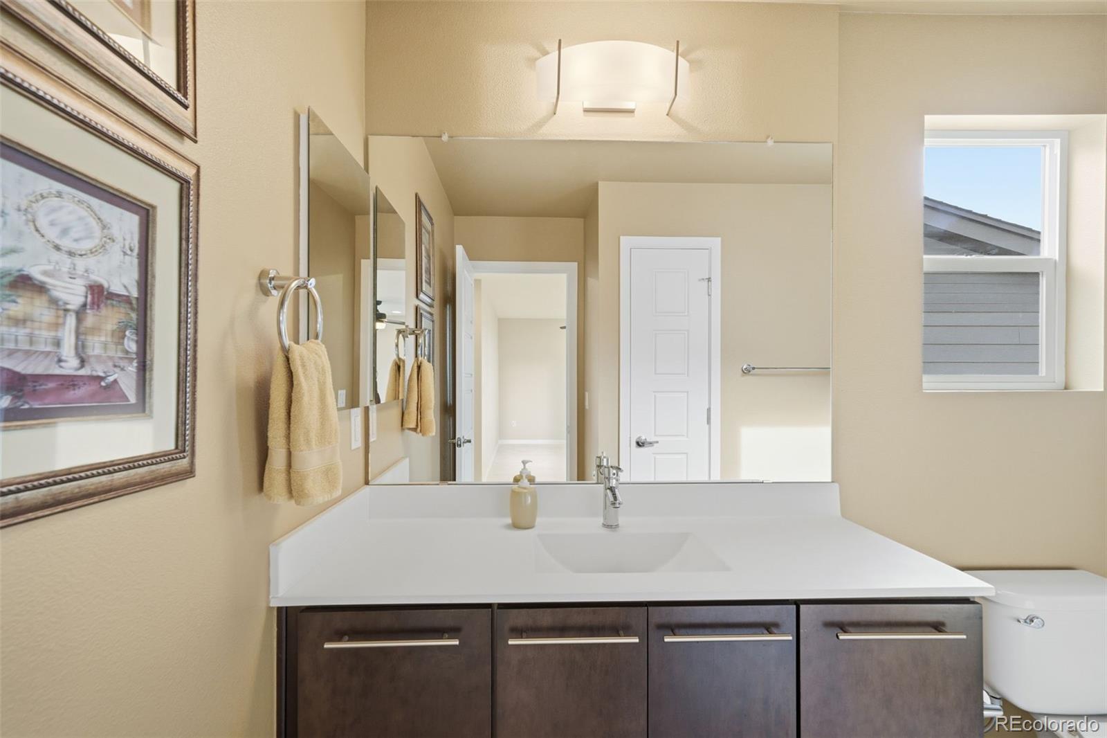 9602 Dunning Circle Highlands Ranch, CO 80126 - Photo 36 of 50 a bathroom with a sink vanity and a mirror