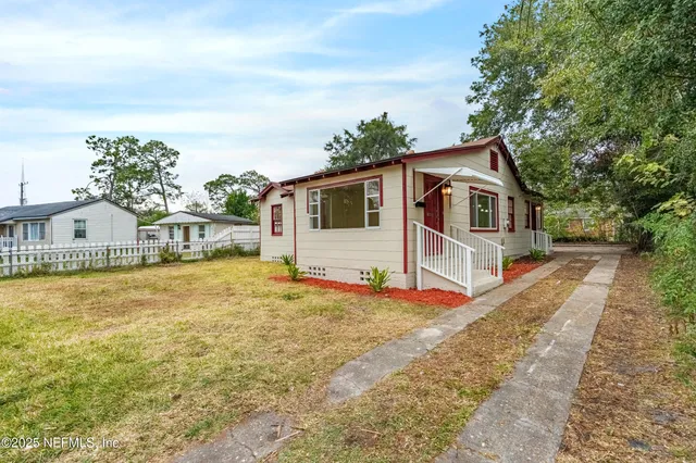 a front view of a house with a yard and seating area