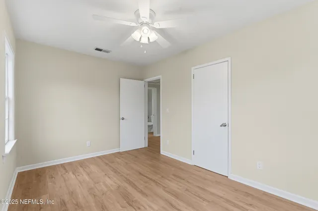 a view of a house with backyard and trees