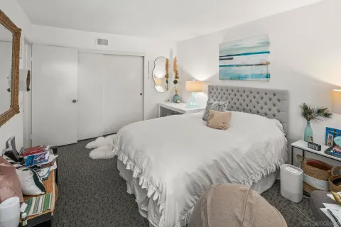 a bedroom with a bed and a night stand