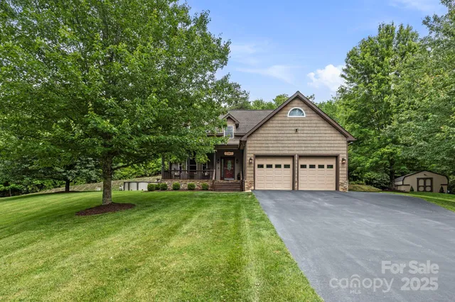 a front view of a house with a yard and trees