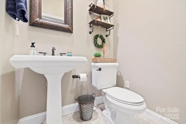 a bathroom with a sink toilet and mirror