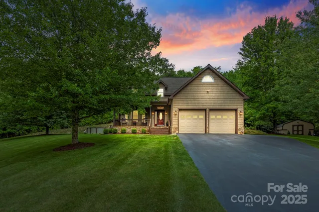 a front view of a house with a yard and trees