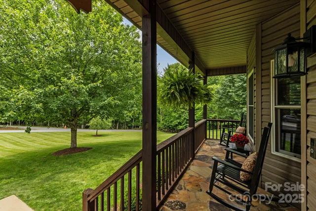 a view of a porch with furniture and garden