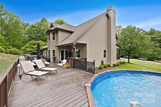 a view of a house with swimming pool and sitting area