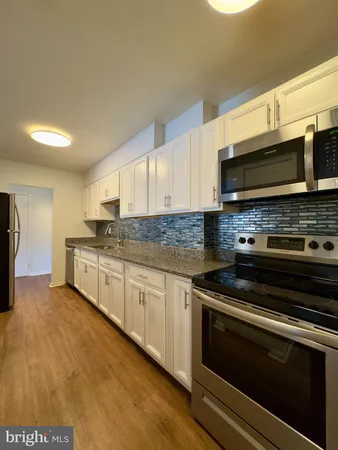 a kitchen with stainless steel appliances a stove a microwave sink and cabinets