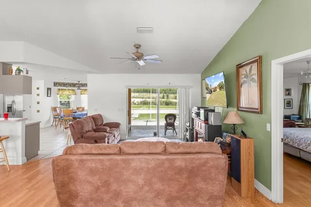 a living room with furniture white walls and a chandelier